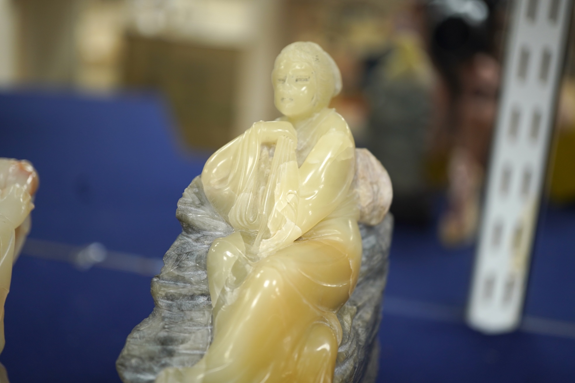 Three Chinese Shoushan stone figures of ladies and an associated stand, tallest 14cm